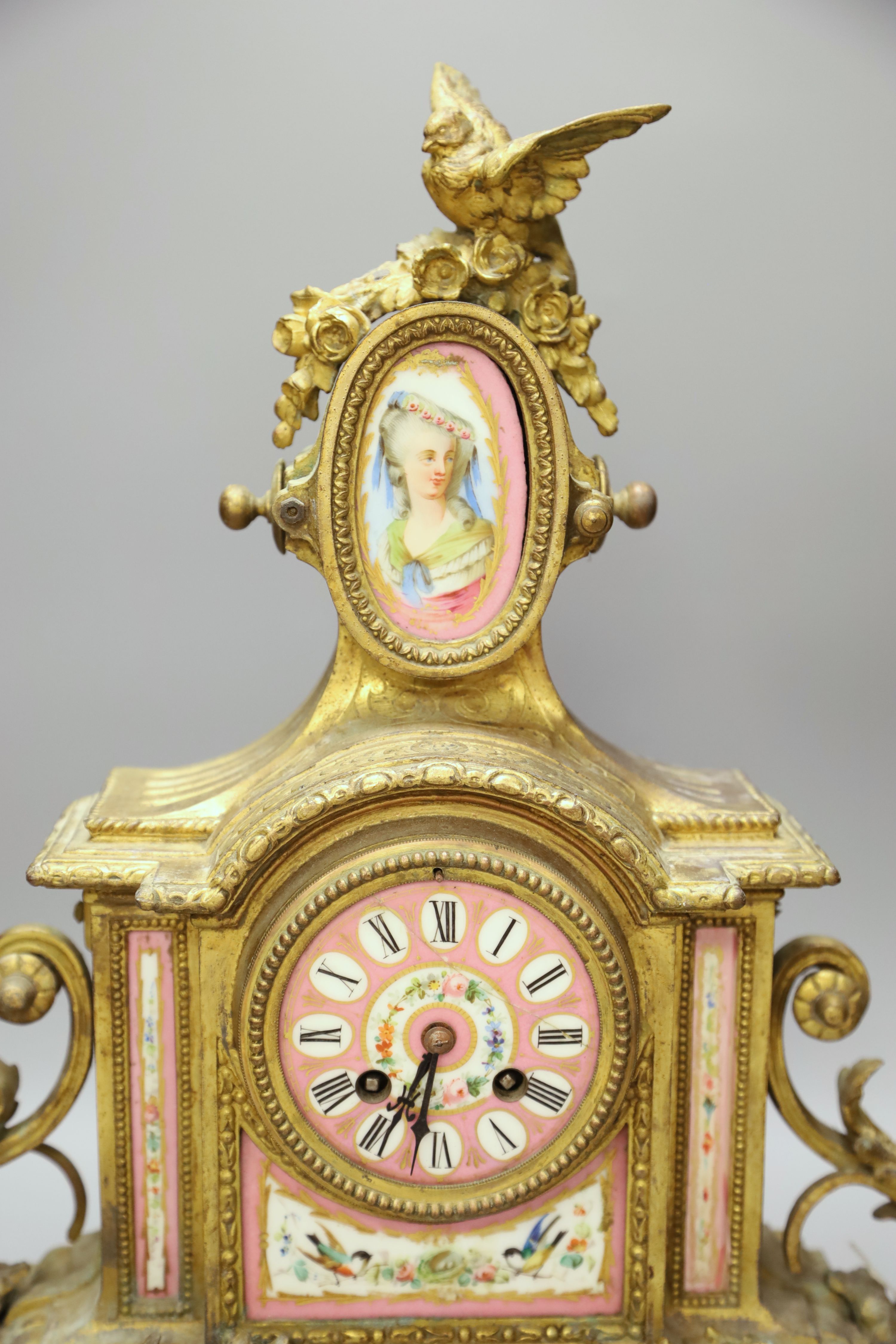 A French gilt metal mantel clock with Sevres-style panels, height 46cm